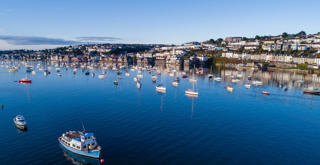 Boats moored up in Falmouth harbour at dawn